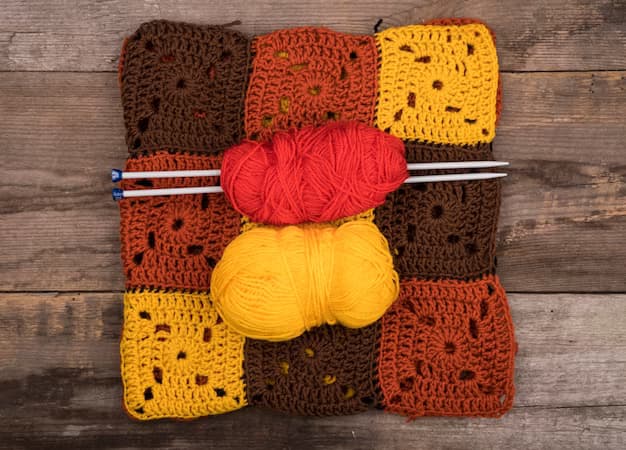 Knitted patterns on a wooden table, top view