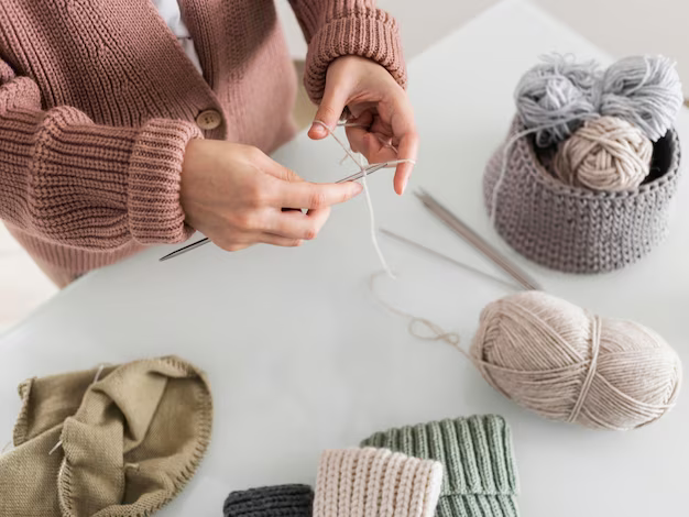 Top view, woman knitting