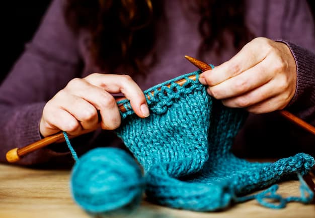 Woman knitting with wooden knitting needles, close-up view