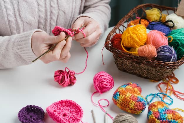 A woman knits, next to a basket of wool balls