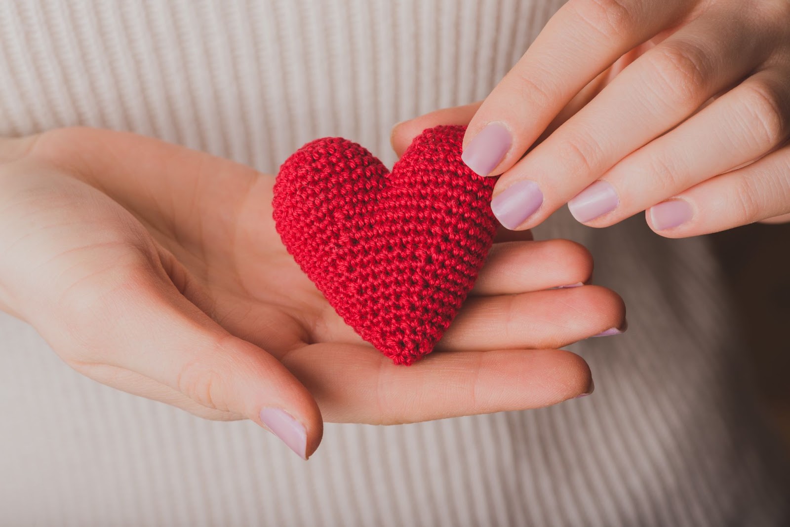 woman holding teddy heart